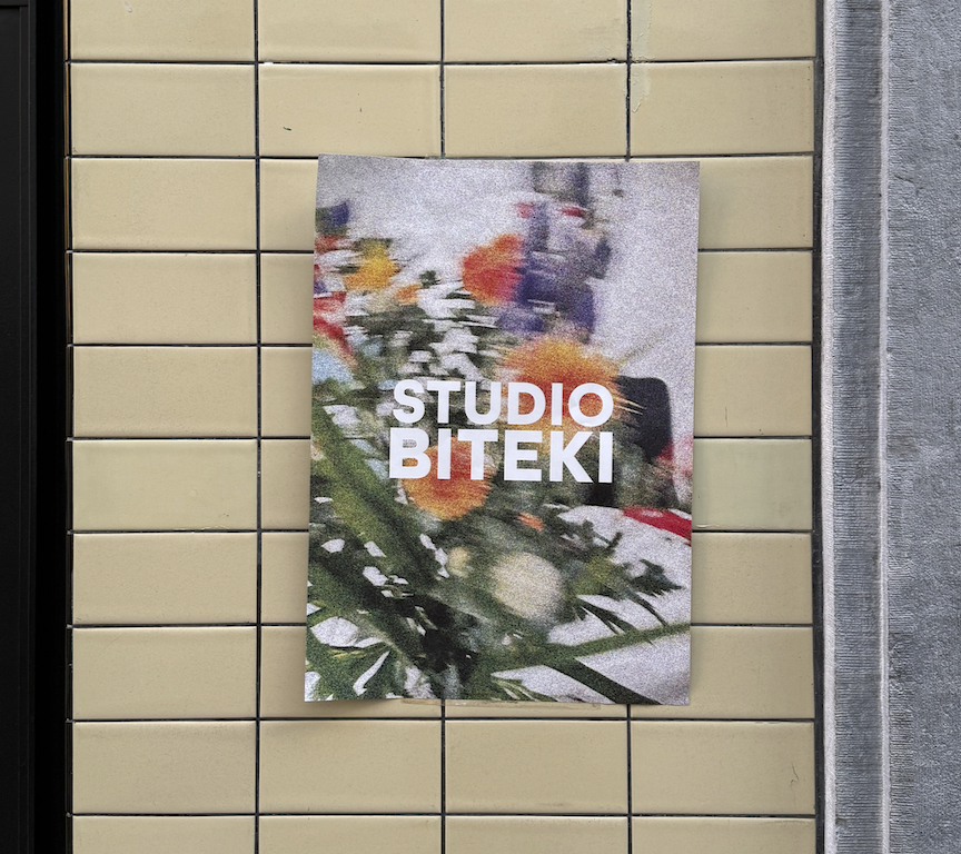 a floral poster of Studio Biteki on a cream tiled wall